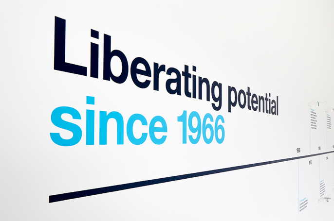 Close-up of core brand message 'Liberating potential' on wall