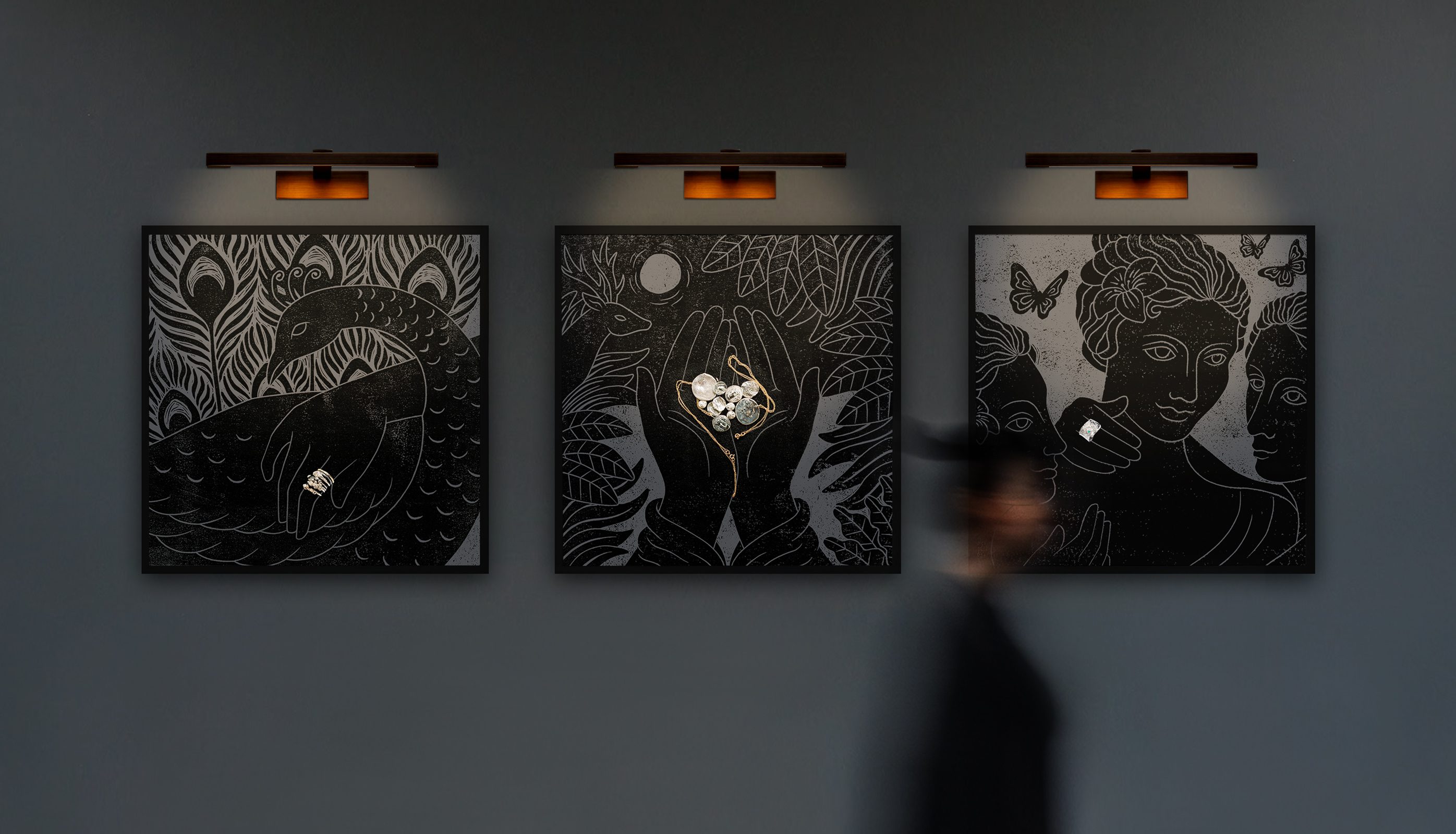 Three framed illustrations on a dark wall depicting mythical scenes that interact with photography of silver jewellery