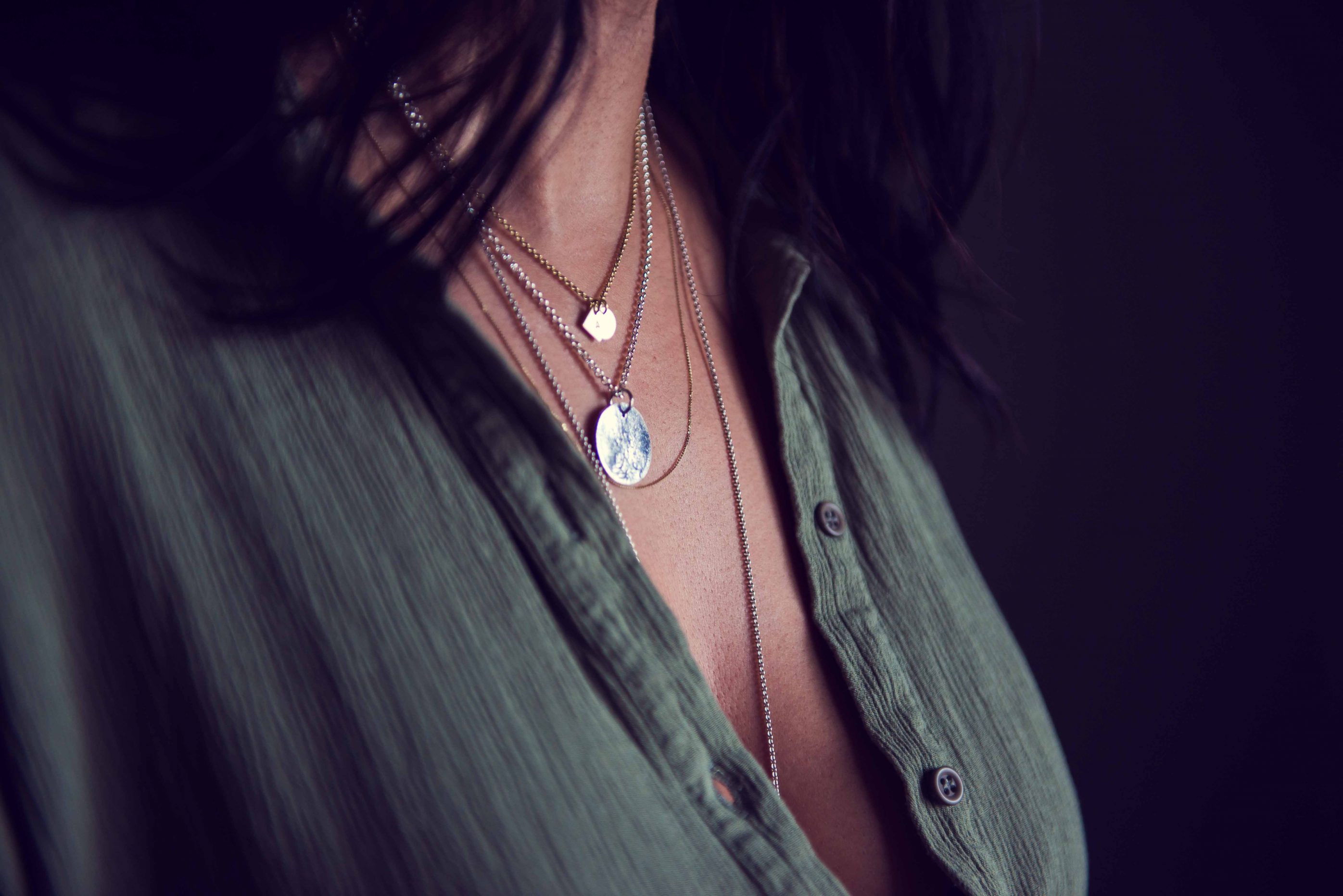 Close-up of silver jewellery around woman's neck