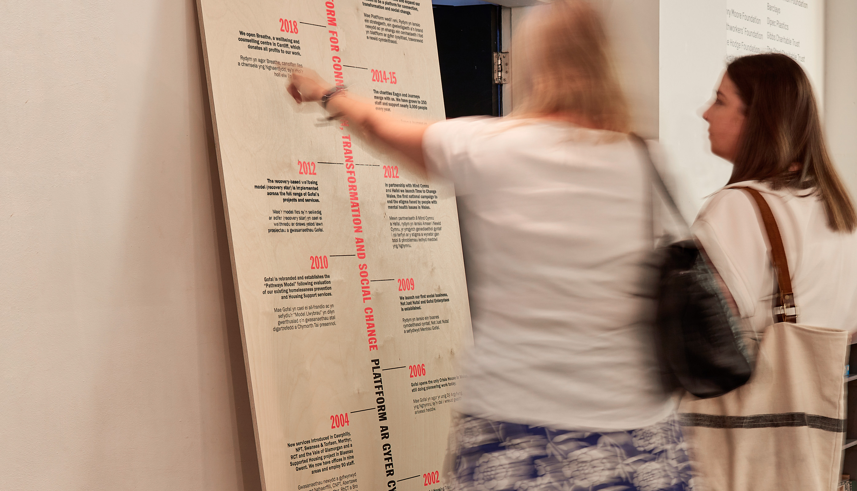 Image showing two woman looking at a branded timeline event stand