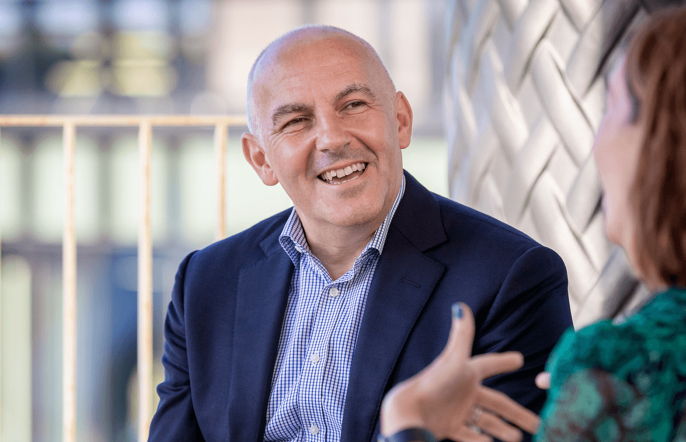 Business man smiling and in discussion with woman