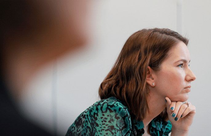 Dynamic photo of woman concentrating in meeting