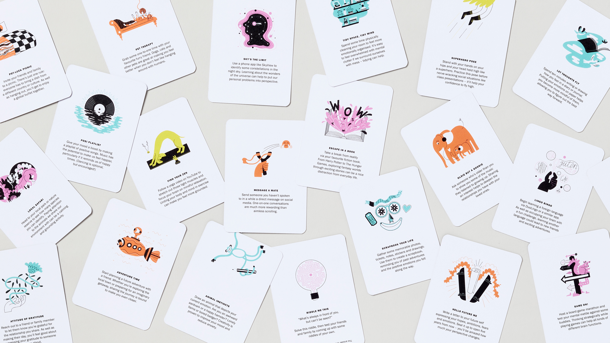 Large selection of mental wellbeing cards depicting activities through illustration, randomly placed on a grey background