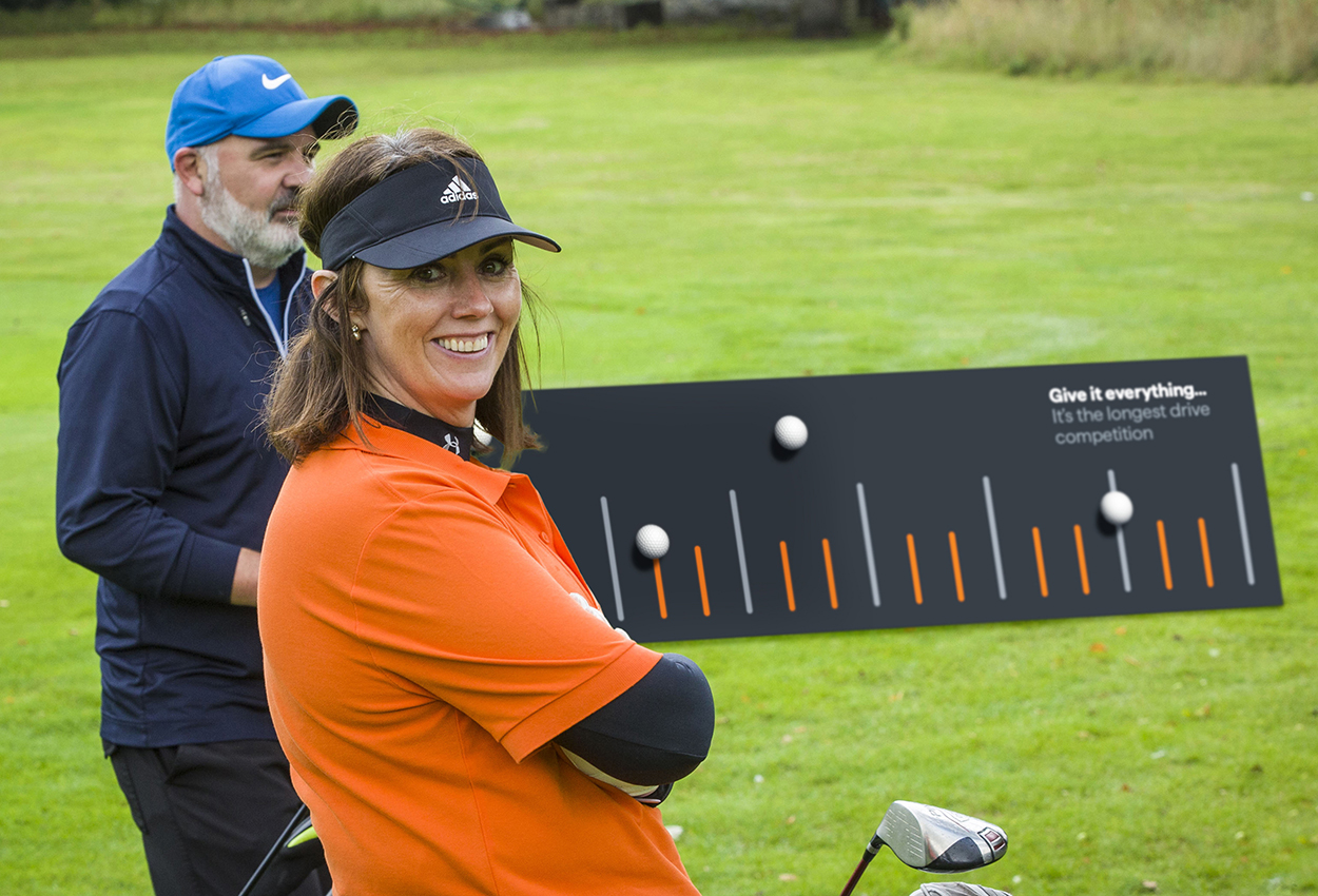 Male and female golfer on course next to event branded banner