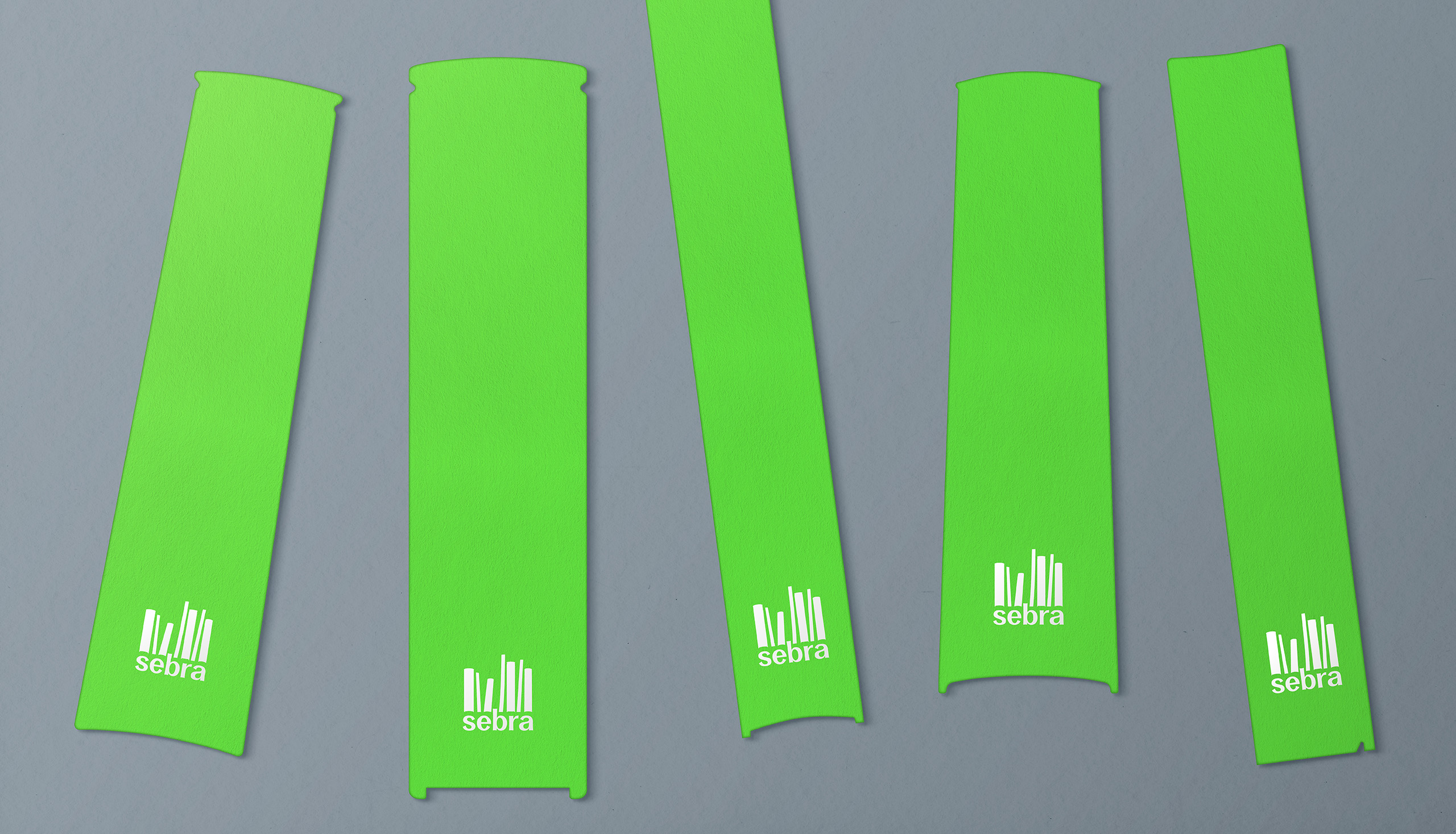Branded green bookmarks that echo the logotype sat on a grey background