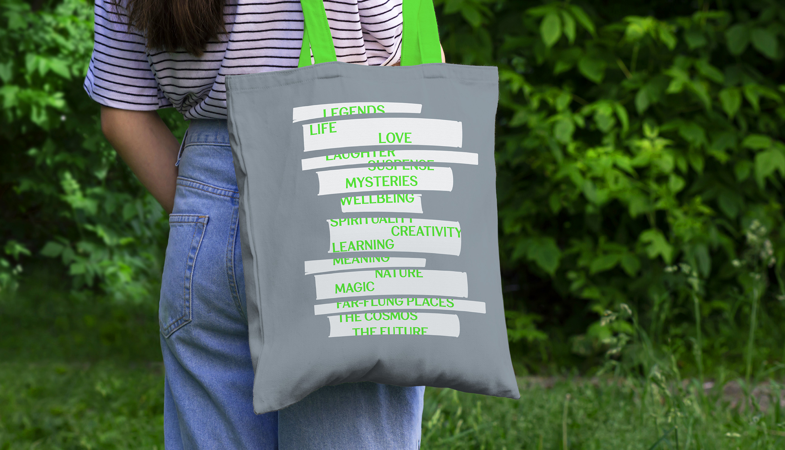 Branded grey tote bag with design that uses book silhouettes with messages within