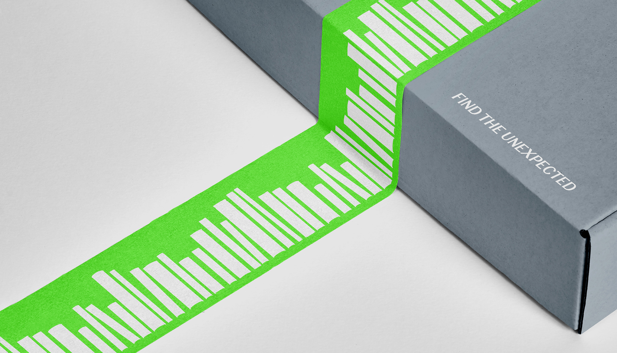 Branded green packaging tape with graphic pattern of striped book silhouettes on grey box